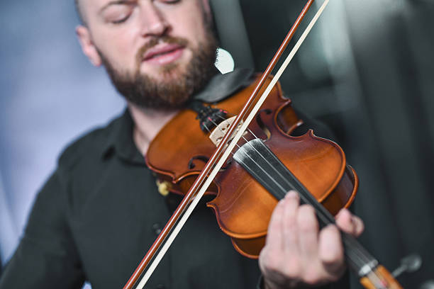 istock Violinist Playing Bow Across Strings During Live Music Session, Focused Expression and Passion 2245319386