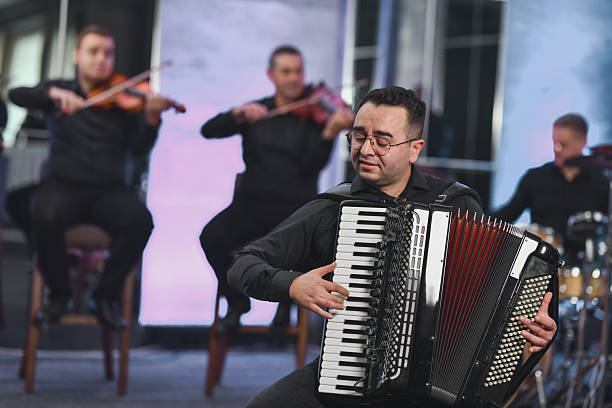 A skilled accordionist performs passionately on stage, while a string ensemble plays in the background, creating a rich live-music scene filled with rhythm and emotion.