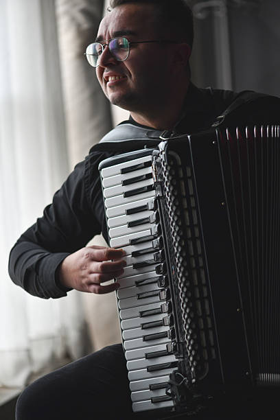 istock Musician Playing Accordion Near Window Light During Expressive Live Performance Portrait 2245319702