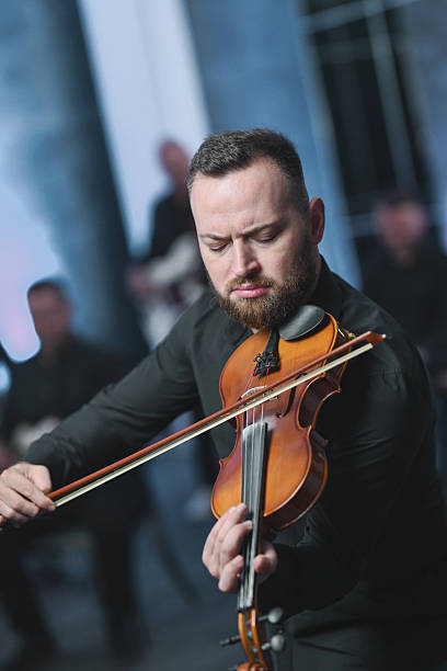 istock Violinist Focused In Live Session Plays Rich Melodies In An Intimate Setting 2245319832