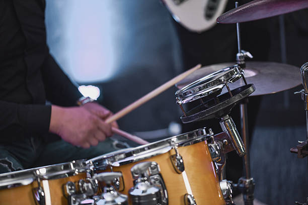A musicians playing an electric guitar, the image is close up on the hands and the atmosphere is quite warm and dramatic