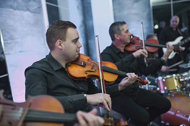 istock Violinist in a Live Music Session With Ensemble Playing Together 2245320300