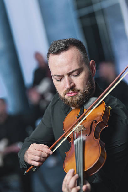 istock Violinist Focused In Live Session Plays Rich Melodies In An Intimate Setting 2245320471
