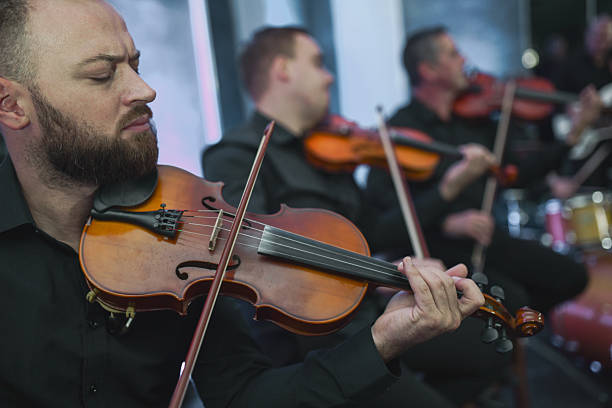 Violinist in a Live Music Session With Ensemble Playing Together