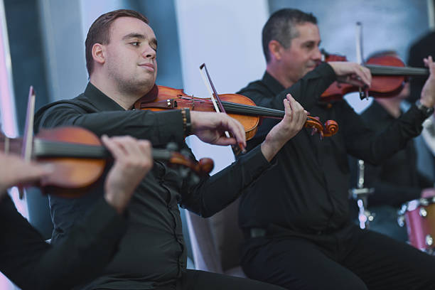 istock Violinists Playing in a Live Ensemble Session With Focused Expressions 2245320767
