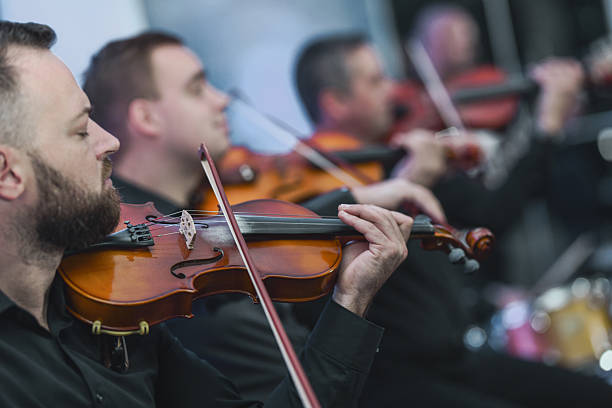 istock Violinists Performing in Black Attire During a Live Ensemble Session 2245320786
