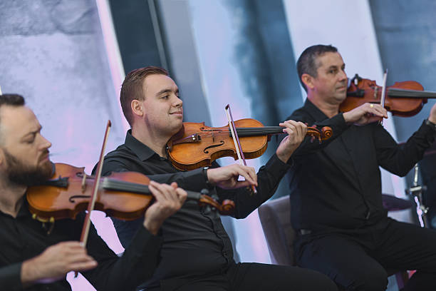istock Violinists Performing in Black Attire During a Live Ensemble Session 2245321021