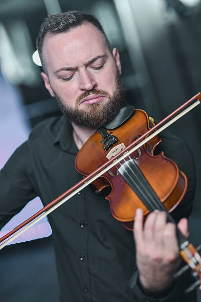 istock Violinist Playing Bow Across Strings During Live Music Session, Focused Expression and Passion 2245321998