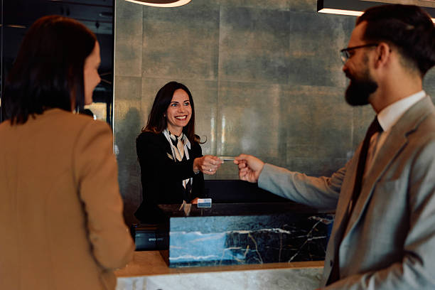 istock Hotel receptionist giving check-in key card to guest 2245323526