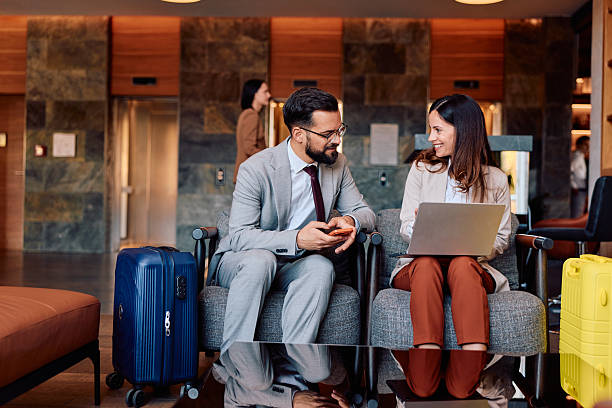 istock Business colleagues discussing project in hotel lobby while traveling 2245323647
