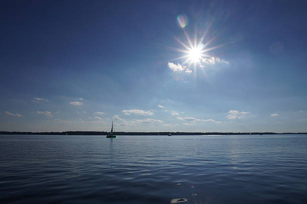 Sailing with catamaran on open sea in late afternoon.