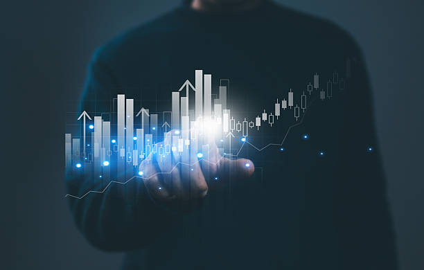 istock Businessman points to digital financial chart with rising bars and bright data points, and investment growth, stock market analysis, trading, financial innovation and future economic success. 2245324492