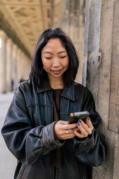 istock Asian Woman Using Mobile Phone Outdoors 2245324811