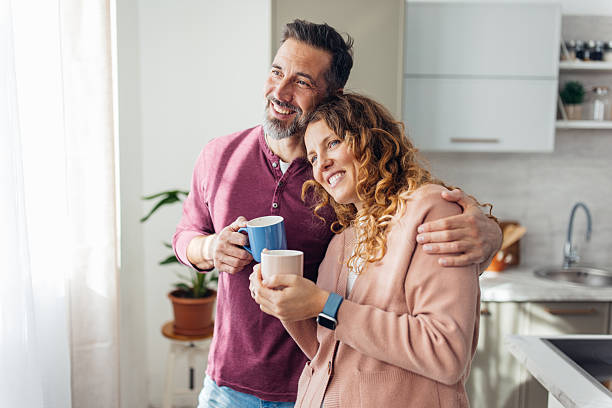 istock Couple Sharing Warm Embrace with Coffee Cups 2245326339