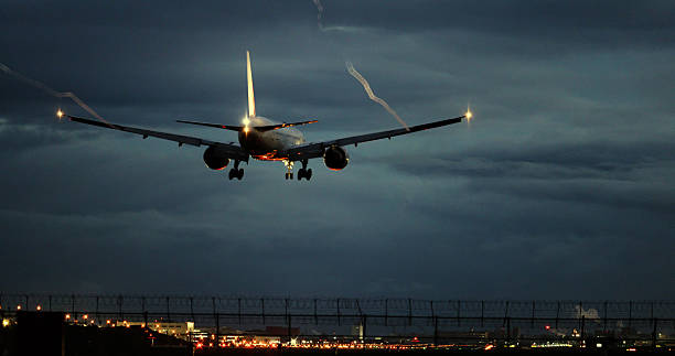 Airplane landing at the airport on a rainy morning with wingtip vortices