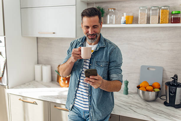 istock Man Checking Phone with Coffee in Hand 2245327925