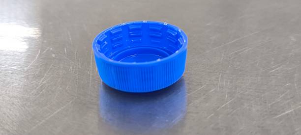 istock Blue soda bottle caps on a stainless steel table 2245328365