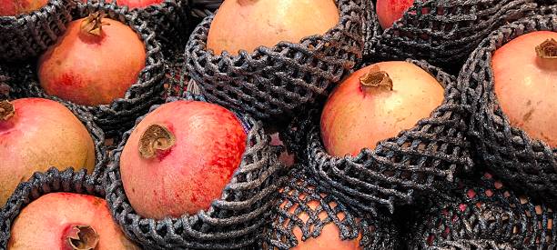istock Red pomegranates in a fruit shop 2245328485