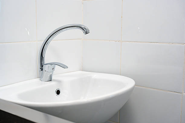 White wash basin and soap dispenser in the bathroom