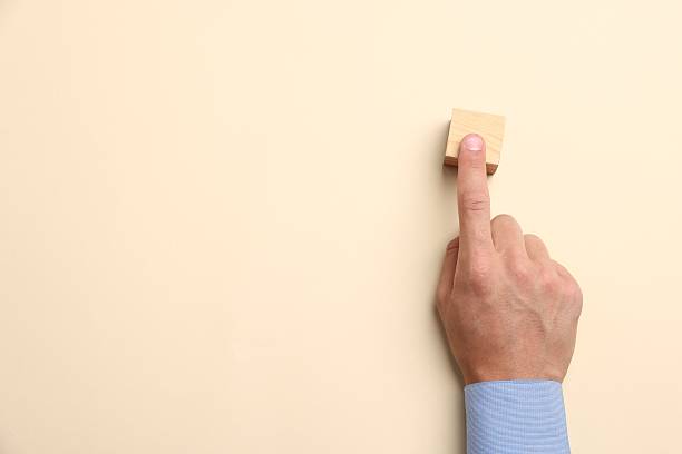istock Man touching wooden cube on beige background, top view. Space for text 2245334573