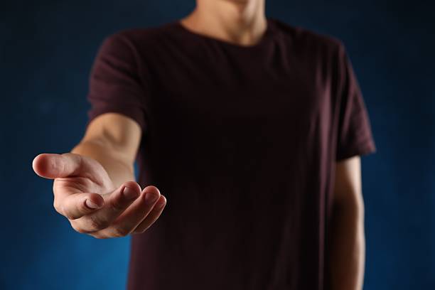 a man in a blue shirt extending his other hand with the palm. This versatile gesture can represent various concepts , making it ideal for business, financial, technological, and conceptual designs.