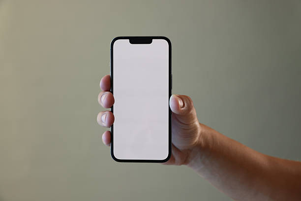 istock Man with modern smartphone on grey background, closeup. Mockup for design 2245336124