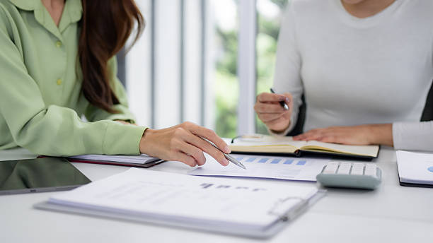 istock Professional business women collaborate analyze financial reports discuss growth strategy meeting room office setting 2245337056