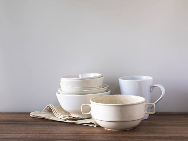 istock Neutral Ceramic Dinnerware Set with Linen Napkin on Wooden Table Minimal Kitchen 2245337133