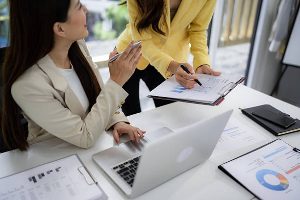istock Asian businesswomen professionals analyze business report data collaborating discussing performance at modern office meeting table 2245337144
