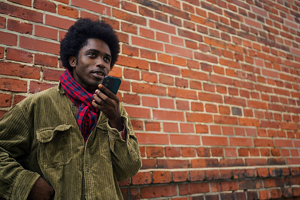 istock Stylish Man Talking on Smartphone Outdoors 2245338296