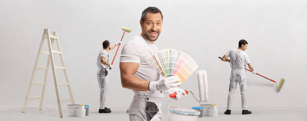 Painters choosing color for wall painting isolated on white background
