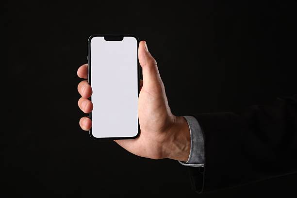 istock Man with modern smartphone on black background, closeup. Mockup for design 2245338859