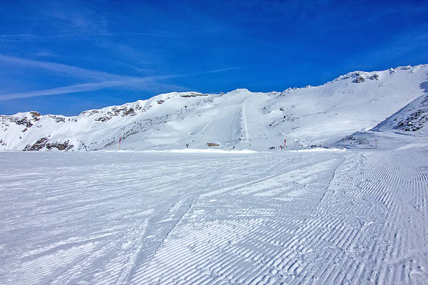 istock Wide, groomed ski slope under blue sky 2245339034
