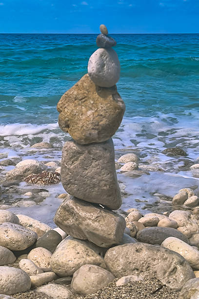 istock Made of stone tower on the beach. Balanced pebbles on beach 2245339141