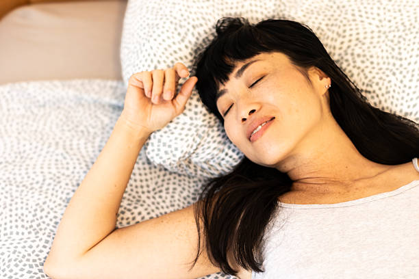 istock Woman peacefully sleeping in bed recovering during morning 2245340870