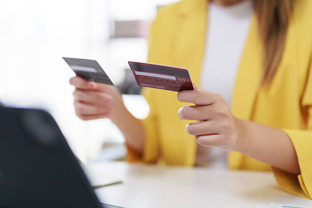 istock Professional woman comparing credit cards, navigating digital payment platform, performing secure online banking transaction on tablet device 2245342095