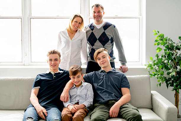 istock A Beautiful happy family sit on sofa at home 2245342283