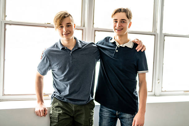 Two happy friends portrait inside house happy