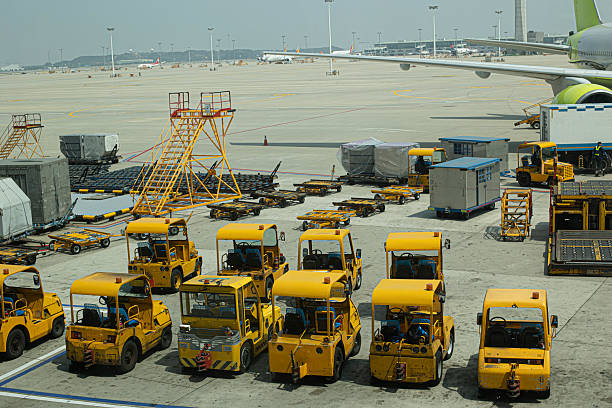 istock Multiple aircraft pushback tractors and ground support vehicles parked on the tarmac at an airport, ready for aircraft towing and ground operations. 2245343054