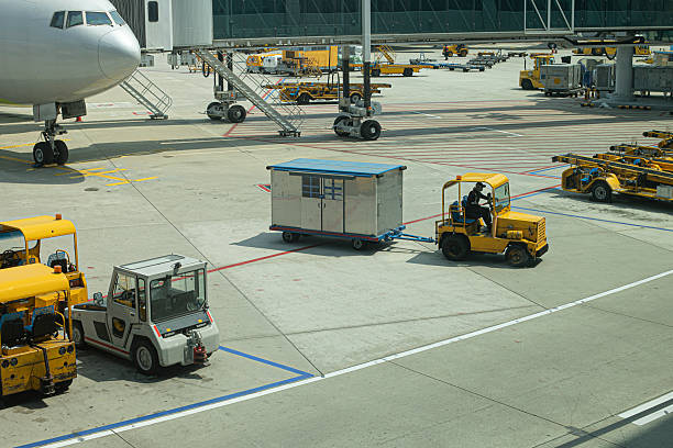 istock Multiple aircraft pushback tractors and ground support vehicles parked on the tarmac at an airport, ready for aircraft towing and ground operations. 2245343062