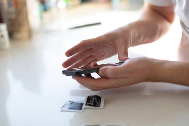 istock The process of replacing a protective glass on a smartphone 2245344000