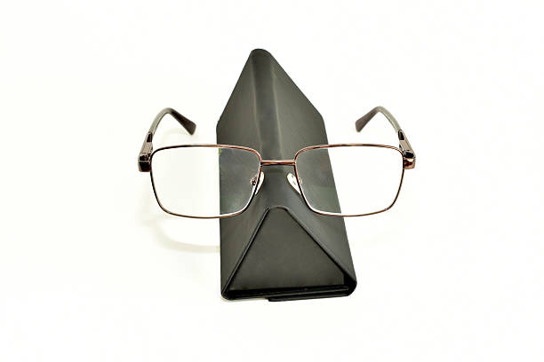 Glasses in a triangle-shaped case made of dark material on a white background.