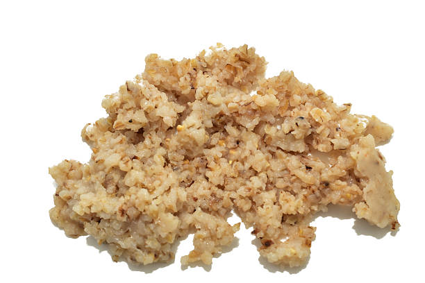 View of boiled barley groats on a white background.