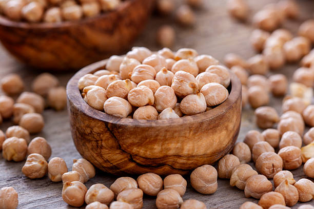 Raw chick peas in dark grey background. Heart shaped food.