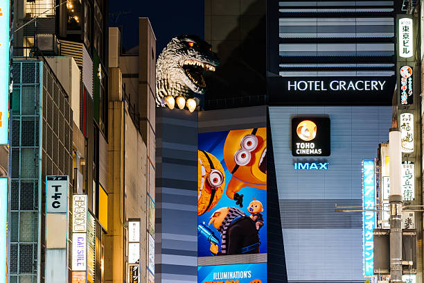 Tokyo, Japan - August 4, 2024: A nighttime view of the Godzilla head atop the Hotel Gracery in Kabukicho, Shinjuku, Tokyo, with illuminated signs and movie posters.