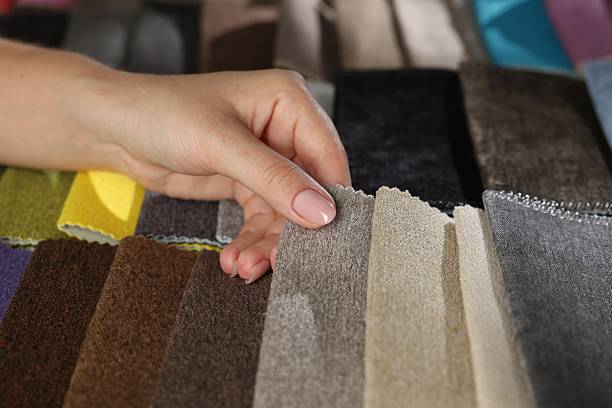 istock Woman choosing fabric among different samples indoors, closeup 2245348888