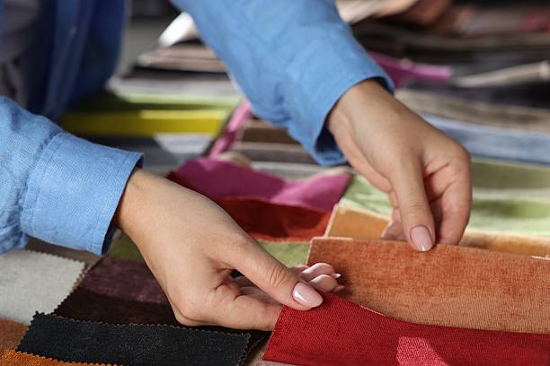istock Woman choosing fabric among different samples indoors, closeup 2245348955