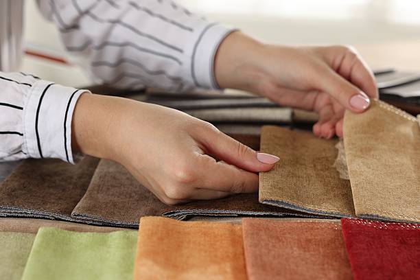 istock Woman choosing fabric among different samples indoors, closeup 2245348987