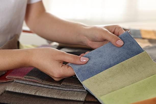 istock Woman choosing fabric among different samples indoors, closeup 2245349038