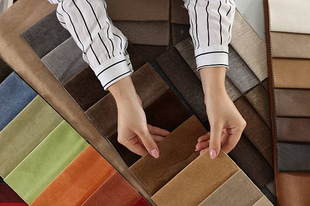 istock Woman choosing fabric among different samples indoors, top view 2245349048